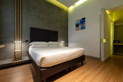 a bedroom with a large bed in a room at Maison Pellegrino in Rome