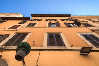 a tall building with a plant in front of it at Romefinestay Apartments Sistina in Rome