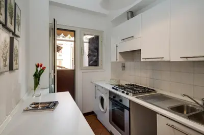 a white kitchen with a sink and a stove at Romefinestay Apartments Sistina in Rome