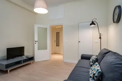 a living room with a couch and a tv at Romefinestay Apartments Sistina in Rome