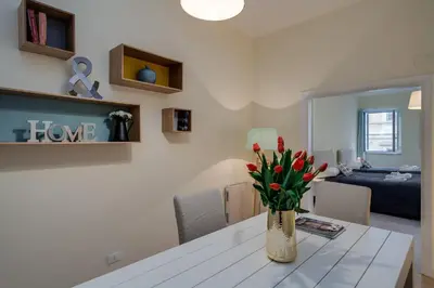 a room with a table with a vase of flowers on it at Romefinestay Apartments Sistina in Rome