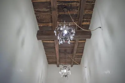 a chandelier hanging from a wooden ceiling at Frattina De Luxe in Rome