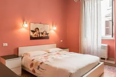 a bedroom with orange walls and a bed and a window at Frattina De Luxe in Rome
