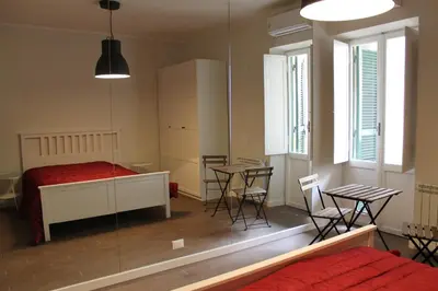 a bedroom with a bed and a table and chairs at Mama Trastevere in Rome