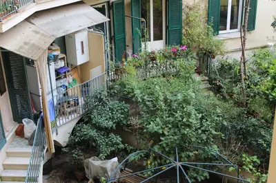 an apartment balcony with plants and flowers on it at Mama Trastevere in Rome