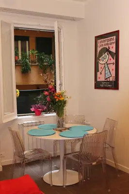 a dining room with a table and chairs and a window at Mama Trastevere in Rome