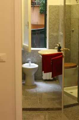 a bathroom with a sink and a toilet and a sink at Mama Trastevere in Rome