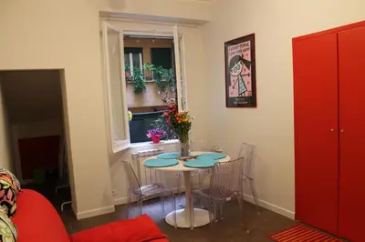a dining room with a table and chairs and a window at Mama Trastevere in Rome