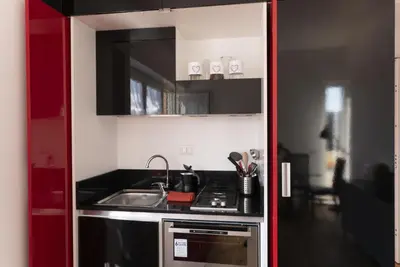 a small kitchen with a sink and a stove at Garibaldi's Camp in Rome
