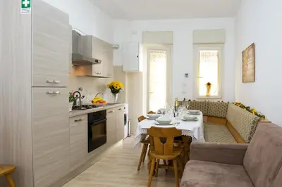 a kitchen and dining room with a table and chairs at Gregory House in Rome