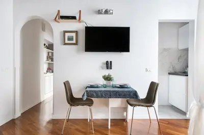 a dining room with a table and chairs at Apartment Near Trevi Fountain in Rome