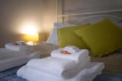 a pile of towels sitting on top of a bed at Apartment Near Trevi Fountain in Rome
