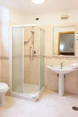 a bathroom with a shower and a sink at Hotel Suite Caesar in Rome