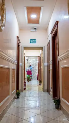 a hallway in a building with a sign on the ceiling at Hotel Suite Caesar in Rome