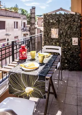 a table with plates of food on a balcony at B&B Zen Trastevere in Rome