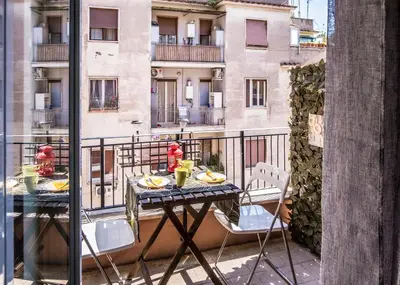 a table and chairs on a balcony with a building at B&B Zen Trastevere in Rome