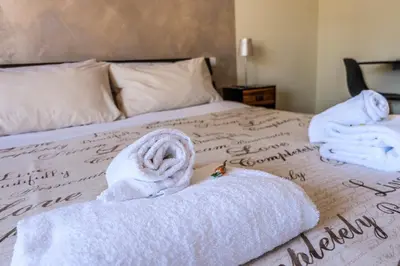 a bed with towels on top of it at B&B Zen Trastevere in Rome