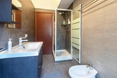 a bathroom with a sink and a shower and a toilet at B&B Zen Trastevere in Rome