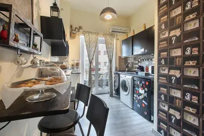 a kitchen with a counter with a table and chairs at B&B Zen Trastevere in Rome