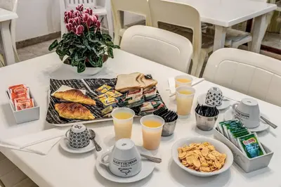 a table with a tray of food and glasses of orange juice at Hotel Altavilla in Rome