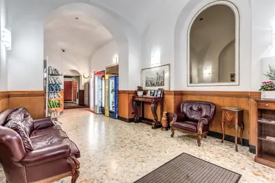 a living room with two leather chairs and a mirror at Hotel Altavilla in Rome