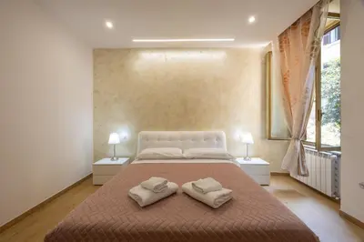 a bedroom with a large bed with two pillows on it at San Pietro Roma Suite in Rome