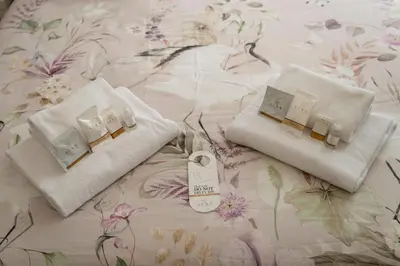 two towels and a thermometer on a bed at San Pietro Roma Suite in Rome