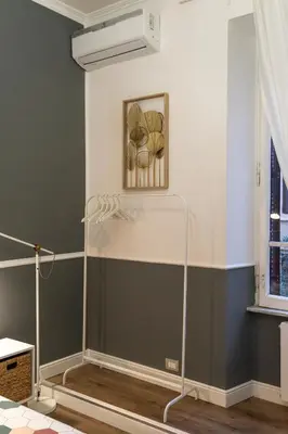 a room with green walls and a painting on the wall at San Pietro Roma Suite in Rome