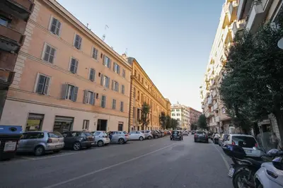a city street with parked cars and buildings at Le Piazze di Roma Sweet Apartment in Rome