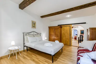 a bedroom with a bed and a table at Deluxe Apartment - Campo dei Fiori in Rome