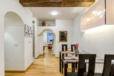a dining room with white walls and a table and chairs at Deluxe Apartment - Campo dei Fiori in Rome