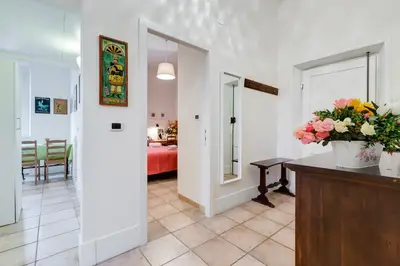 a living room with a vase of flowers on a counter at Domus Ricca Termini in Rome