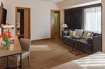 a living room with a couch and a table at Starhotels Metropole in Rome