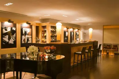 a bar in a restaurant with chairs and tables at Starhotels Metropole in Rome