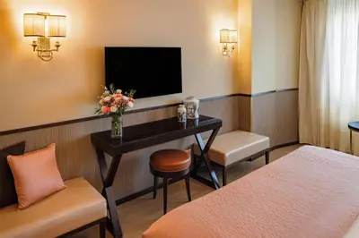 a hotel room with a desk and a tv at Starhotels Michelangelo Rome in Rome