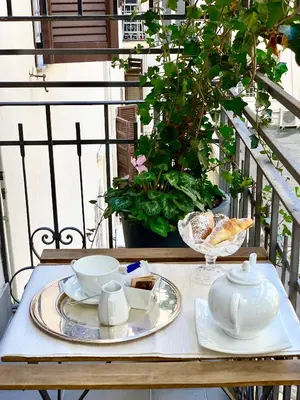 a table with a tea set on a balcony at 900 Piazza del Popolo in Rome