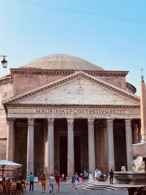 a large building with people walking in front of it at 900 Piazza del Popolo in Rome