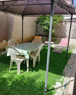 a table and chairs under an umbrella on the grass at San Pietro & Trastevere Home in Rome