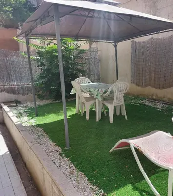 a table and chairs sitting under an umbrella at San Pietro & Trastevere Home in Rome