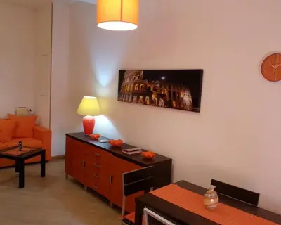 a living room with a couch and a dresser and a lamp at San Pietro & Trastevere Home in Rome