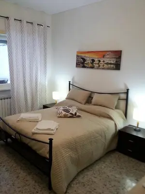 a bedroom with a bed with two towels on it at San Pietro & Trastevere Home in Rome