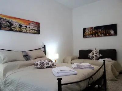 a bedroom with a bed with towels on it at San Pietro & Trastevere Home in Rome