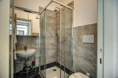 a bathroom with a shower and a sink at Magia at Colosseum in Rome