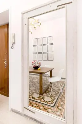 a dining room with a table and a chair at Modern Comfort, Poetic Charm in Rome