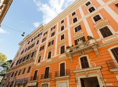 a large orange building with a balcony at Modern Comfort, Poetic Charm in Rome