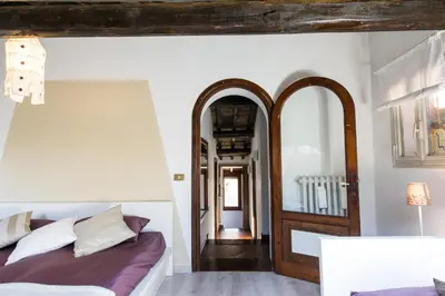 a bedroom with a bed and two mirrors at Lo Chalet di Trastevere in Rome