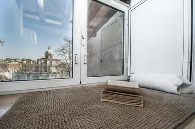 a room with a large window and a rug at Lo Chalet di Trastevere in Rome