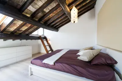 a bedroom with a bed and a wooden ceiling at Lo Chalet di Trastevere in Rome