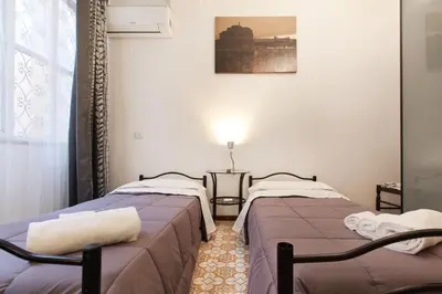 two beds sitting next to each other in a room at BoRooms in Rome