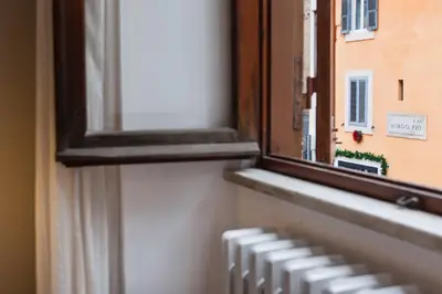a window with a view of a building at BoRooms in Rome